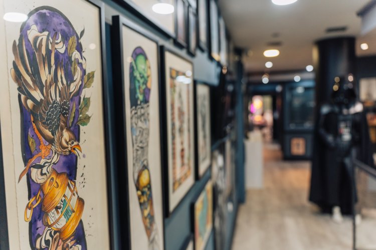 A wall filled with framed tattoo flash designs.