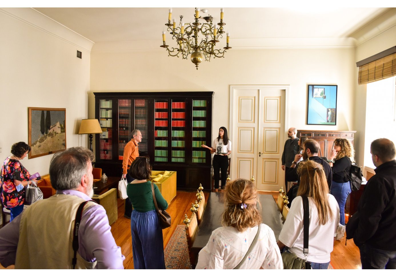 a woman talking to a crowd in a house