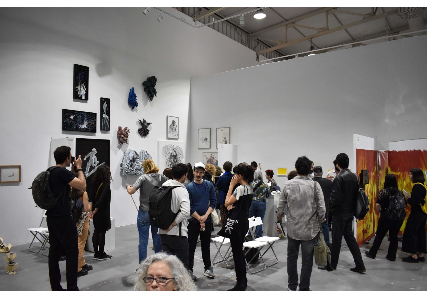 people walking around an exhibition space