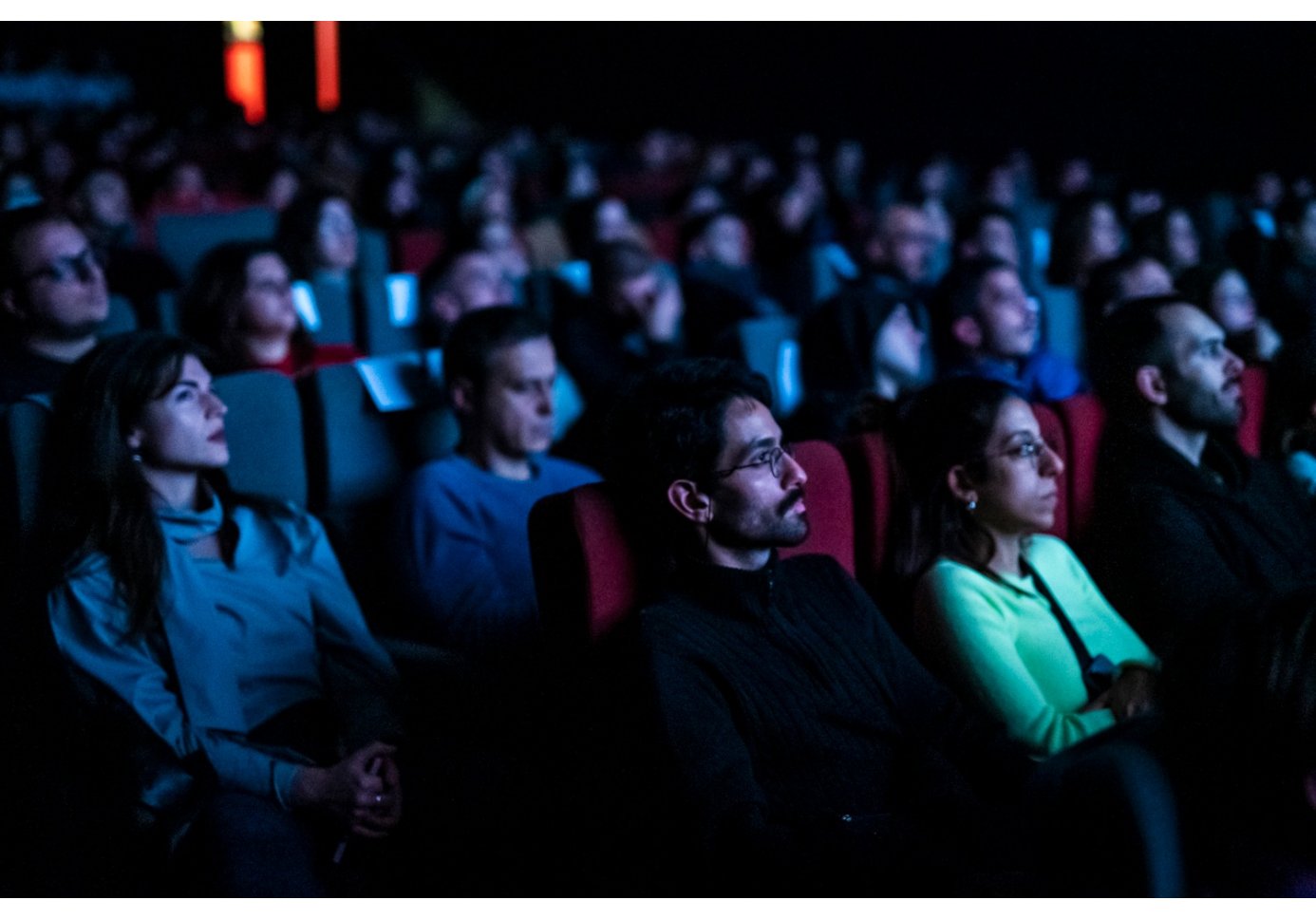 people watching a movie at a movie theatre